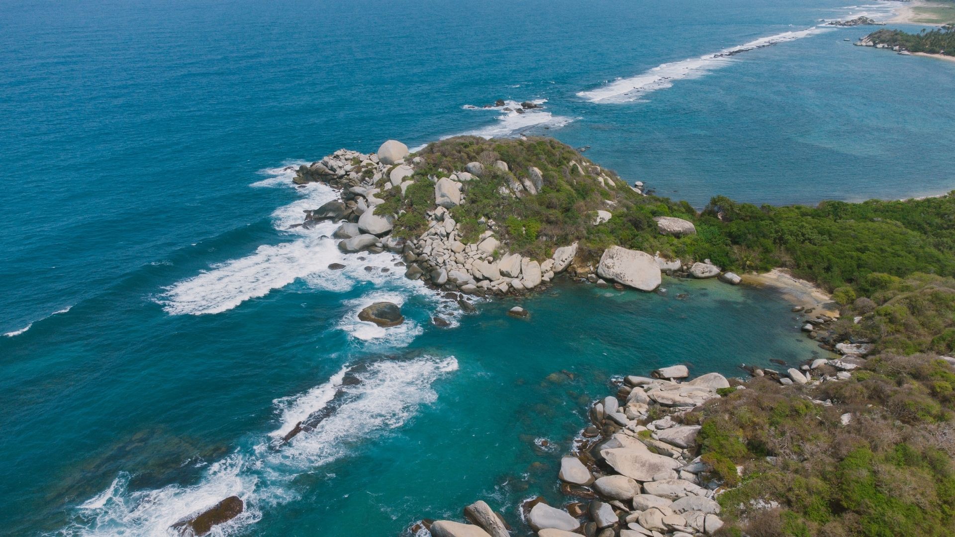 Waves crash along a rocky coastline