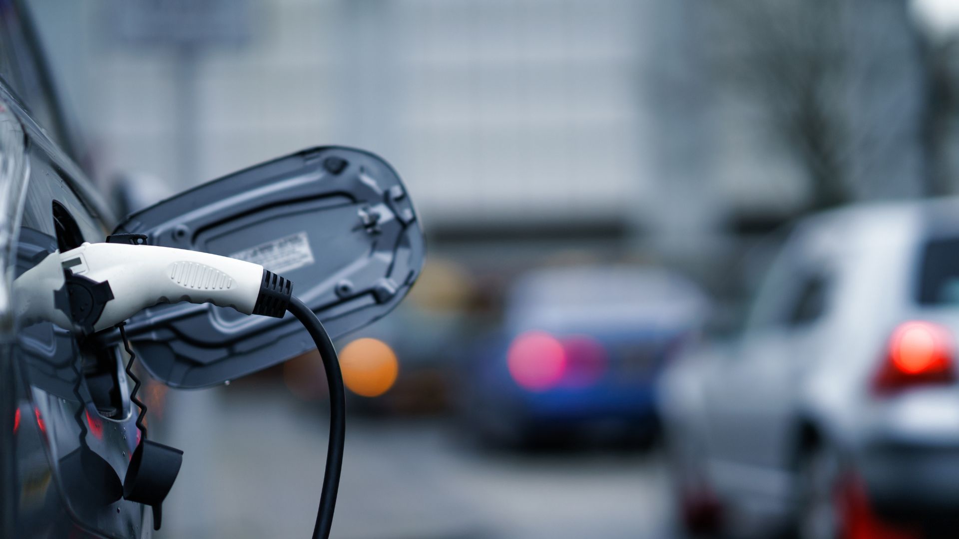 An electric car charging on the street