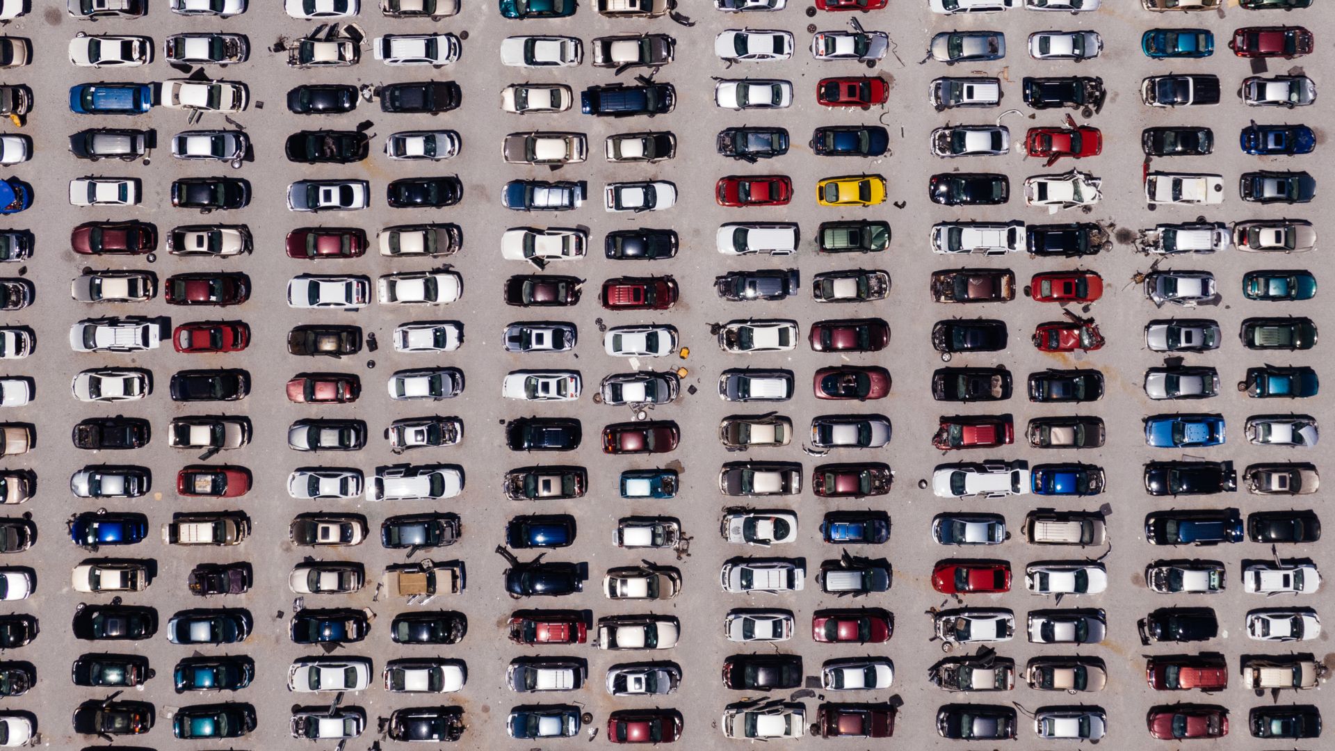 High-up overhead view of a parking lot filled with cars