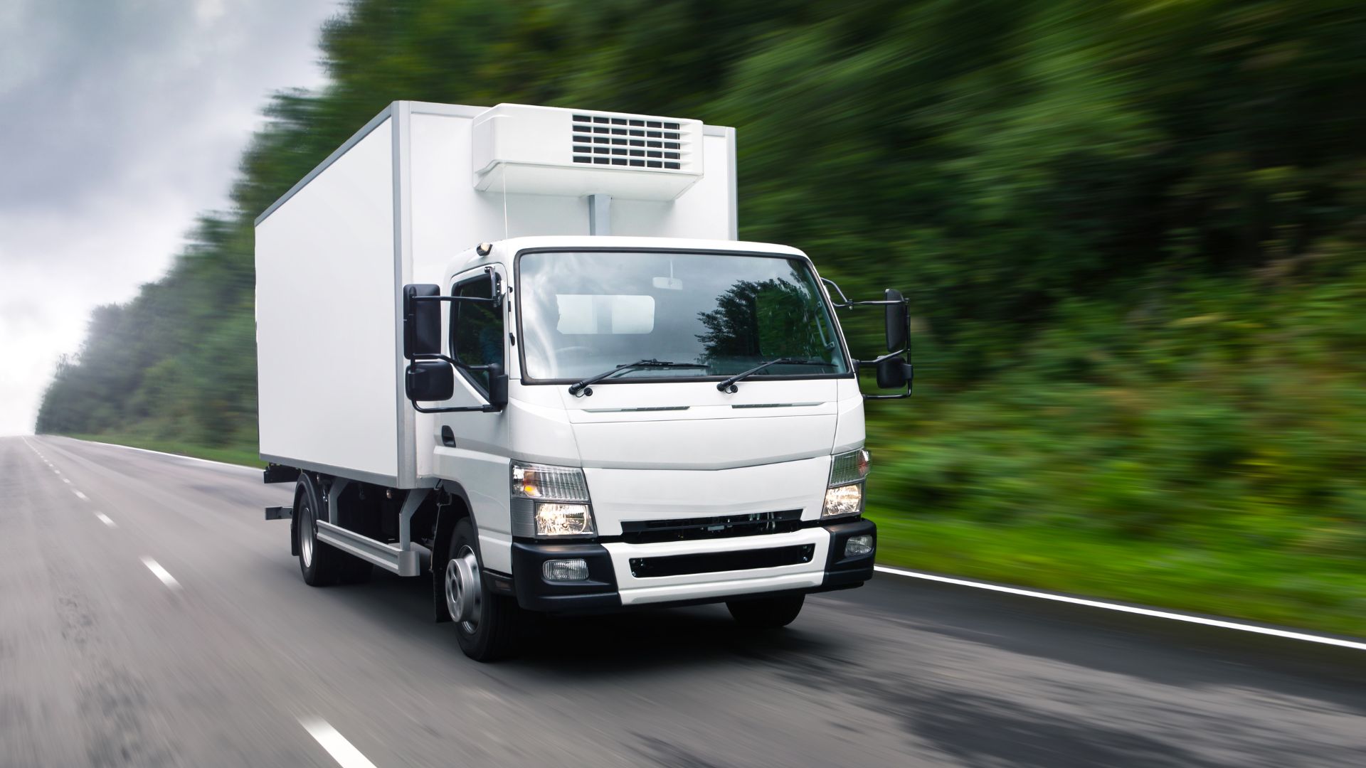 An electric delivery truck speeds down the road