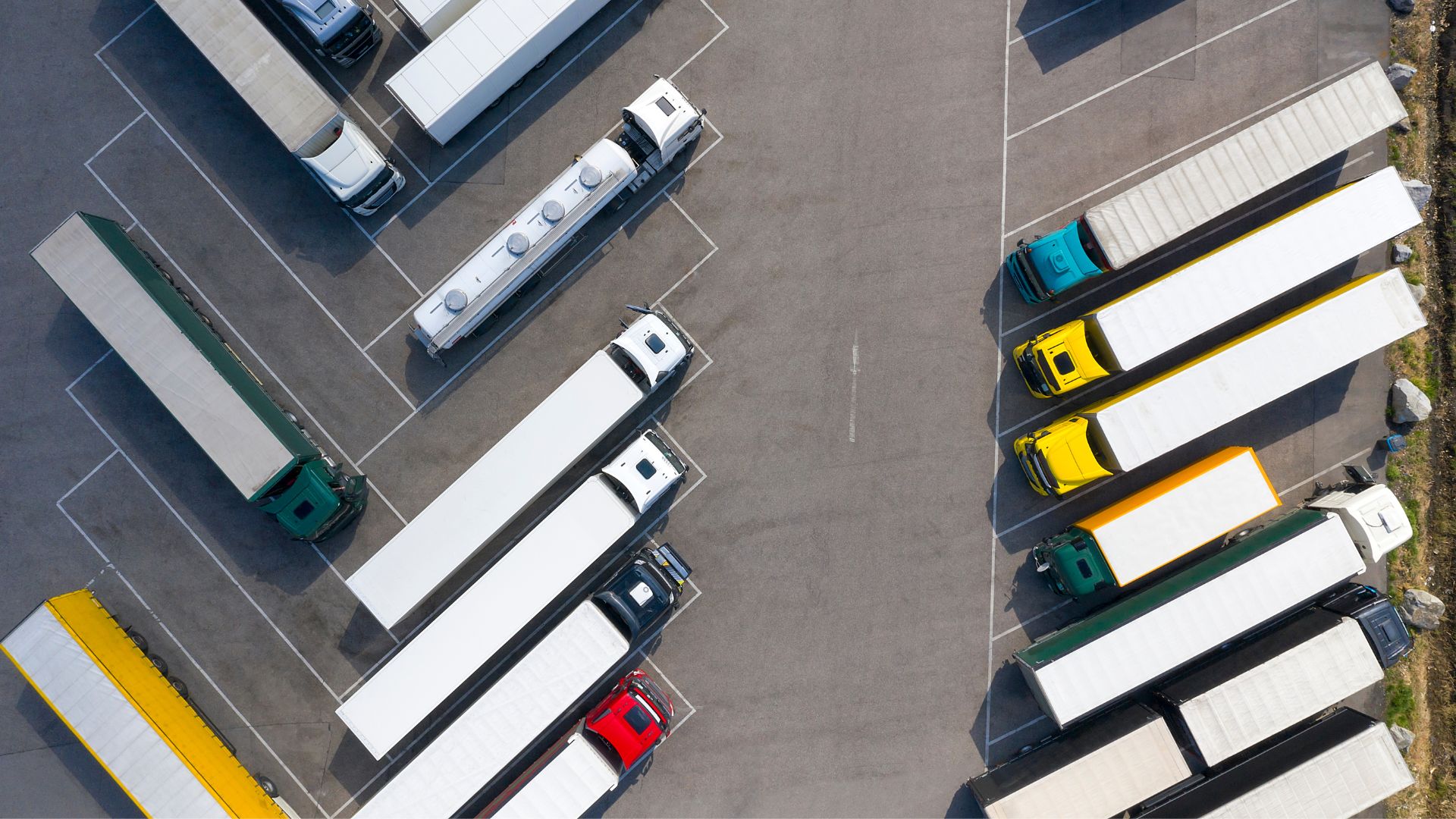 An overhead shot of a bunch of big rigs parked diagonally and really impressively straight -- like so straight and at perfect angles it feels computer generated because how could a human be this good at parking?