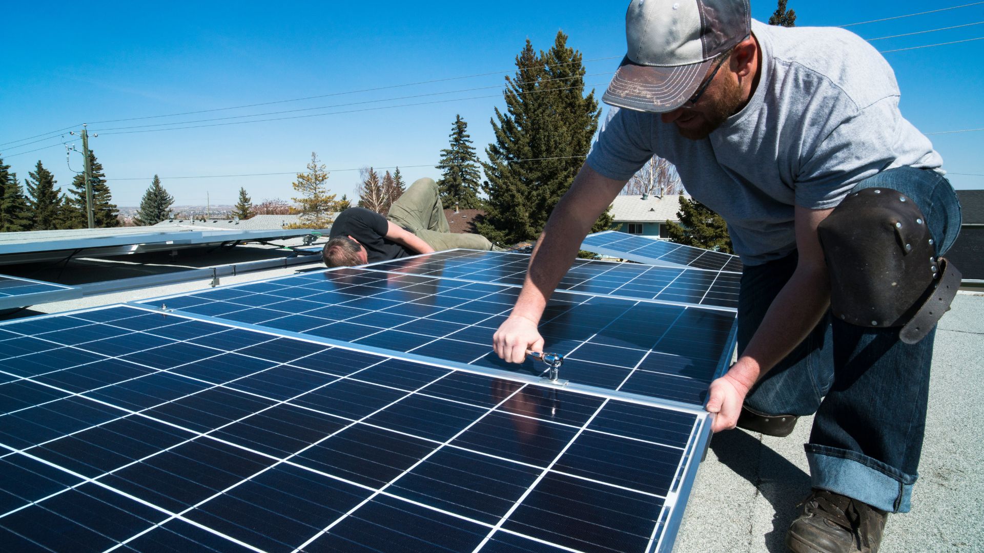 A person installing solar panels which really breaks my vacation theme on this page