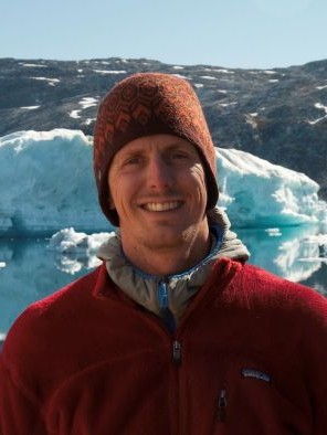Mattias Cape standing in front of a glacier