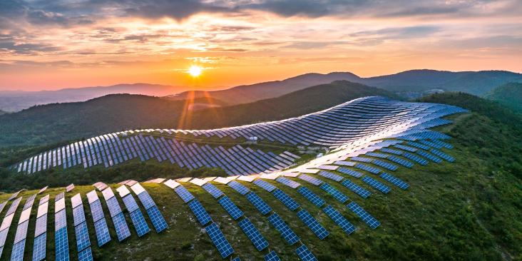 Solar panel installation on mountains with sunrise