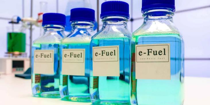 Several bottles of E-fuel lined up side by side