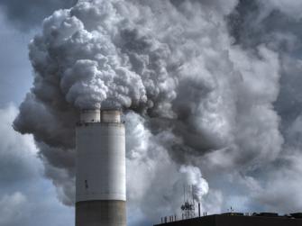 Smoke billows out of a smokestack.