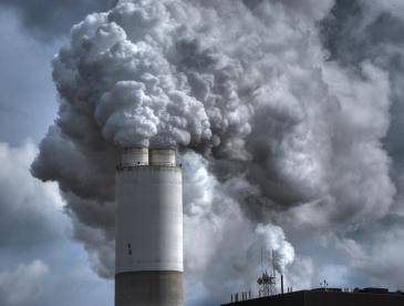 Smoke billows out of a smokestack.